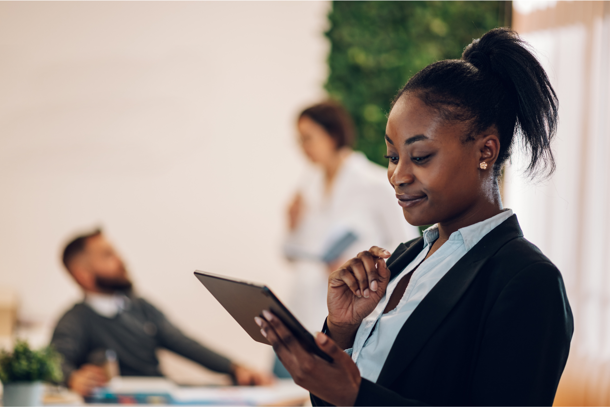 Procurement manager reviewing orders on a tablet in an office setting